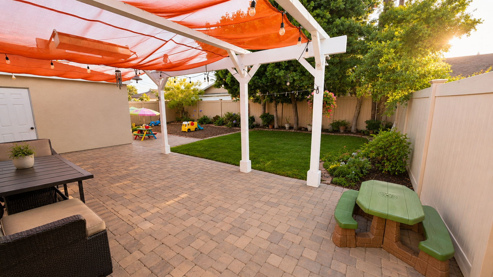 Backyard patio with shade pergola and green lawn