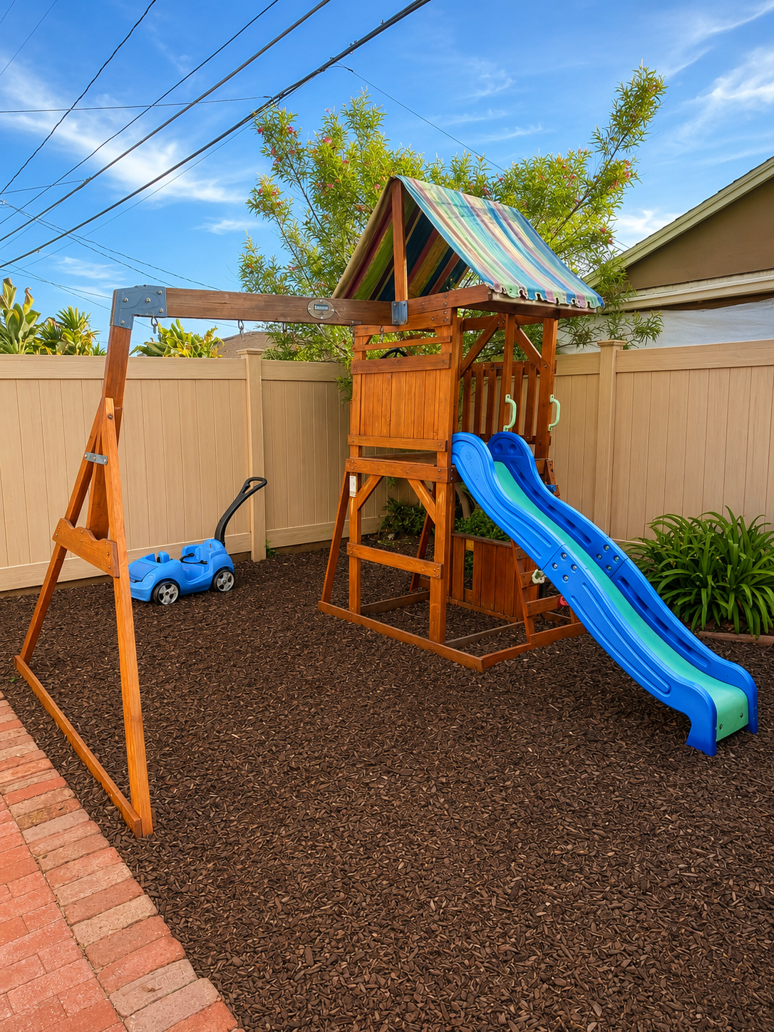 Backyard playground with slide and swing